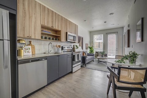 a kitchen and living room with a table and chairs